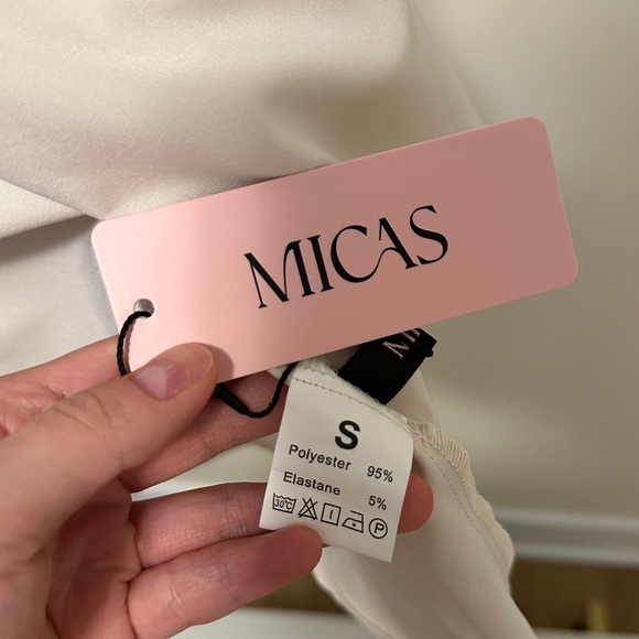 Mini tube dress with featuring a black top part and cream bottom from Micas. - Picture 3 of 5